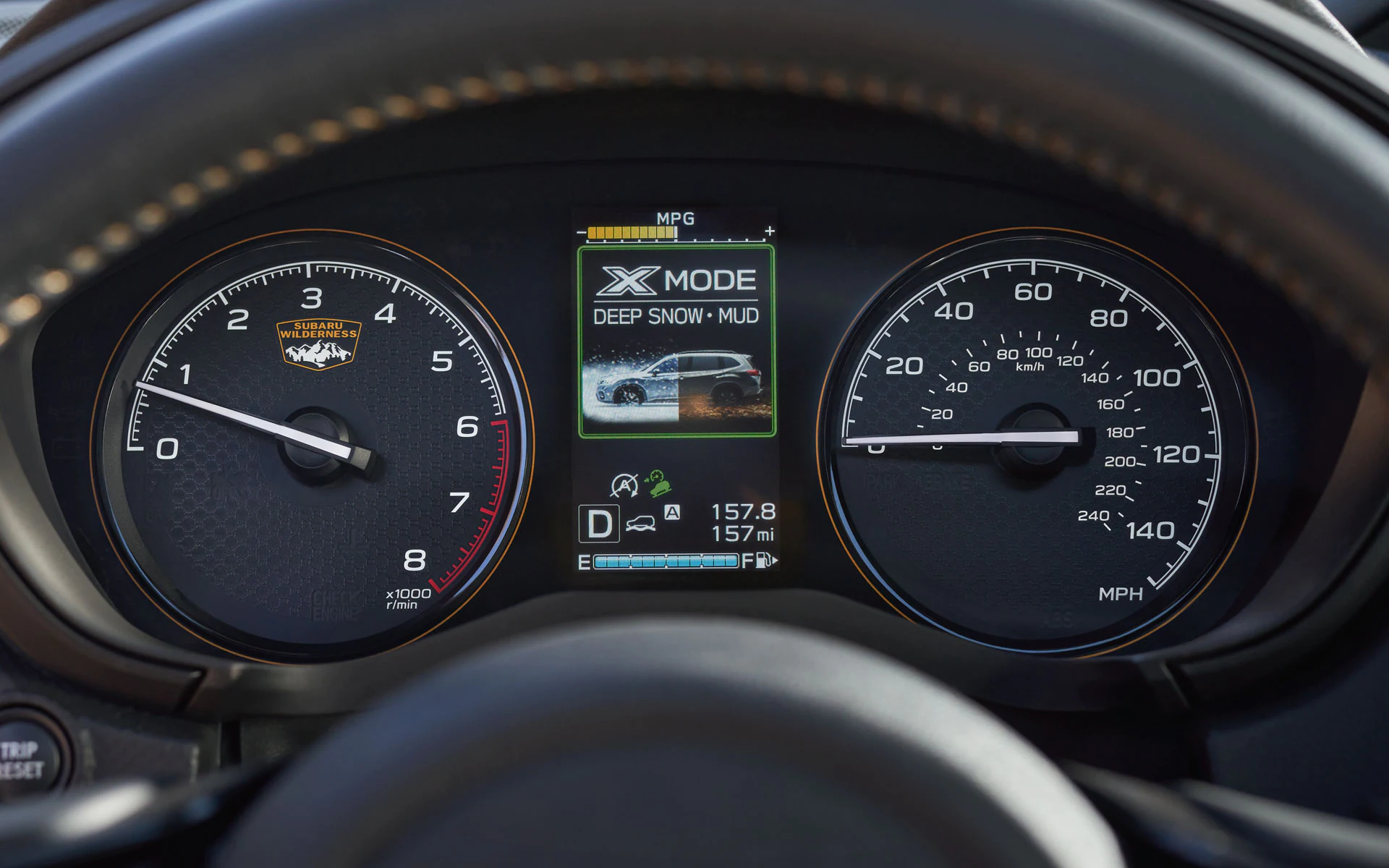 A close up of a hand adjusting the x-mode on the center console of the 2022 Subaru Forester Wilderness.